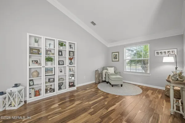 a bed room with a bed window and a chair