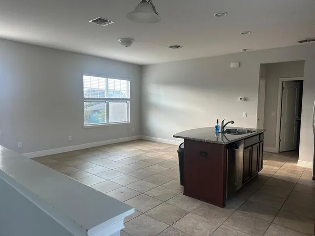 a kitchen with stainless steel appliances granite countertop a sink and a stove