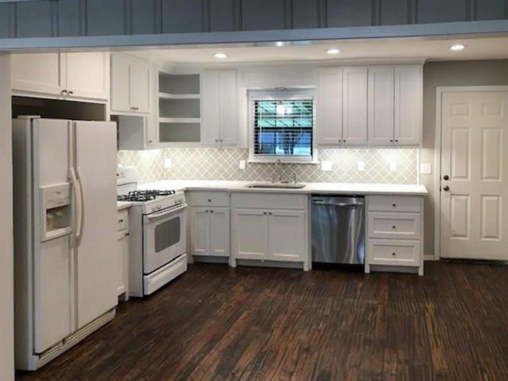 602 West 3rd Street Justin, TX 76247 - Photo 4 of 22 Bright kitchen featuring white cabinetry, light countertops, and a patterned tile backsplash