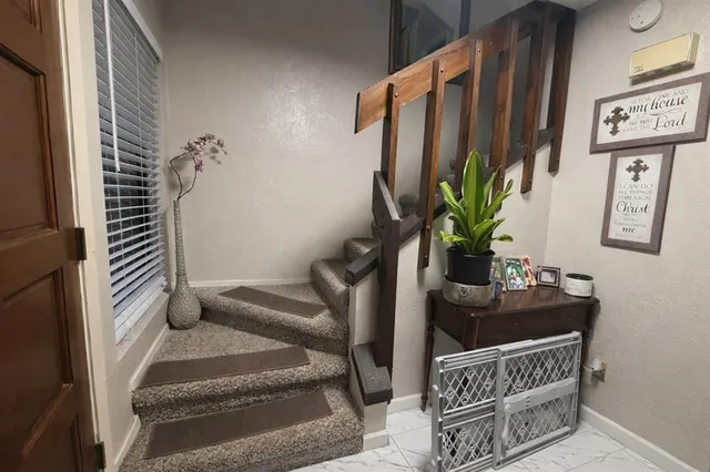 a balcony with furniture and a potted plant