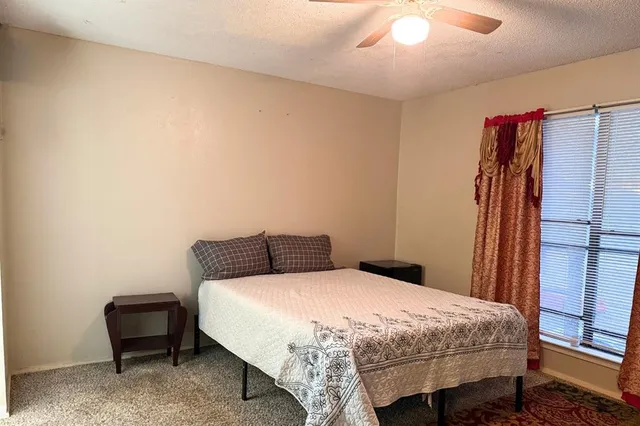 a bedroom with a bed and a chair