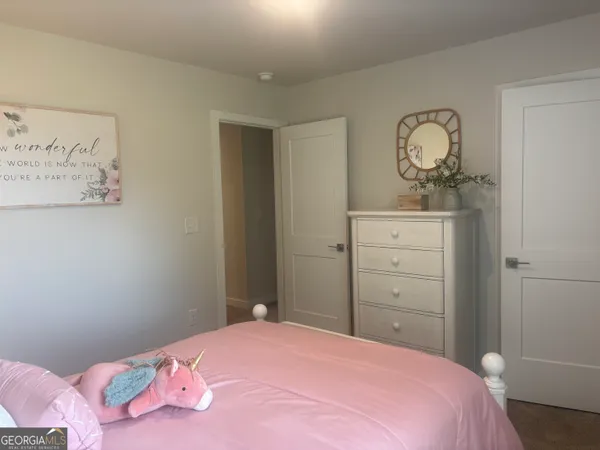 a bedroom with a bed and a dresser