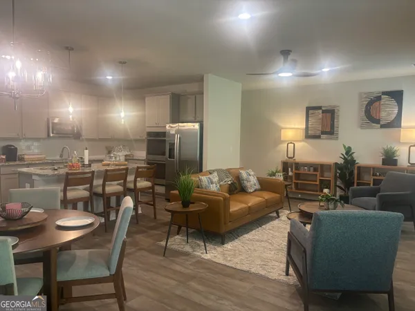 a living room with furniture and kitchen view