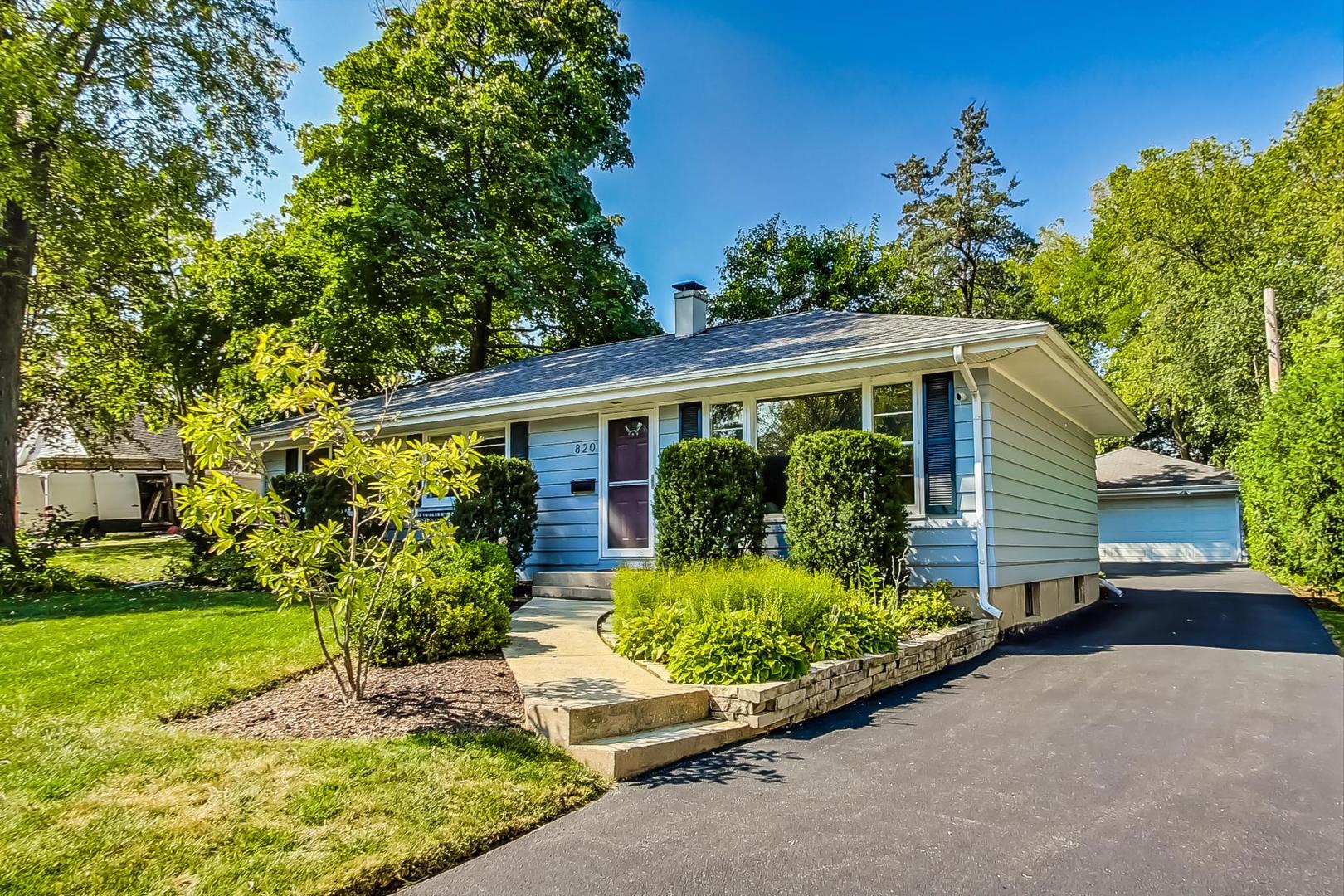 820 Sunset Road Wheaton, IL 60189 - Photo 2 of 32 a front view of a house with garden