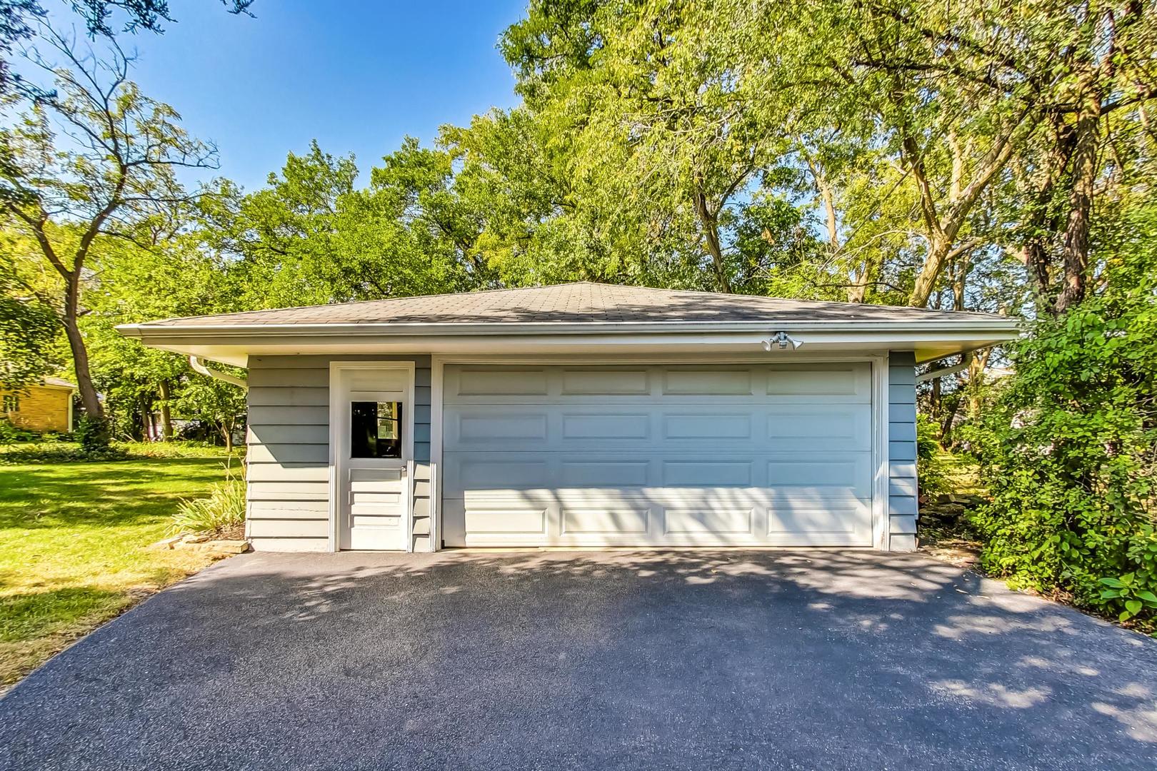 820 Sunset Road Wheaton, IL 60189 - Photo 30 of 32 a front view of a house with a yard and garage