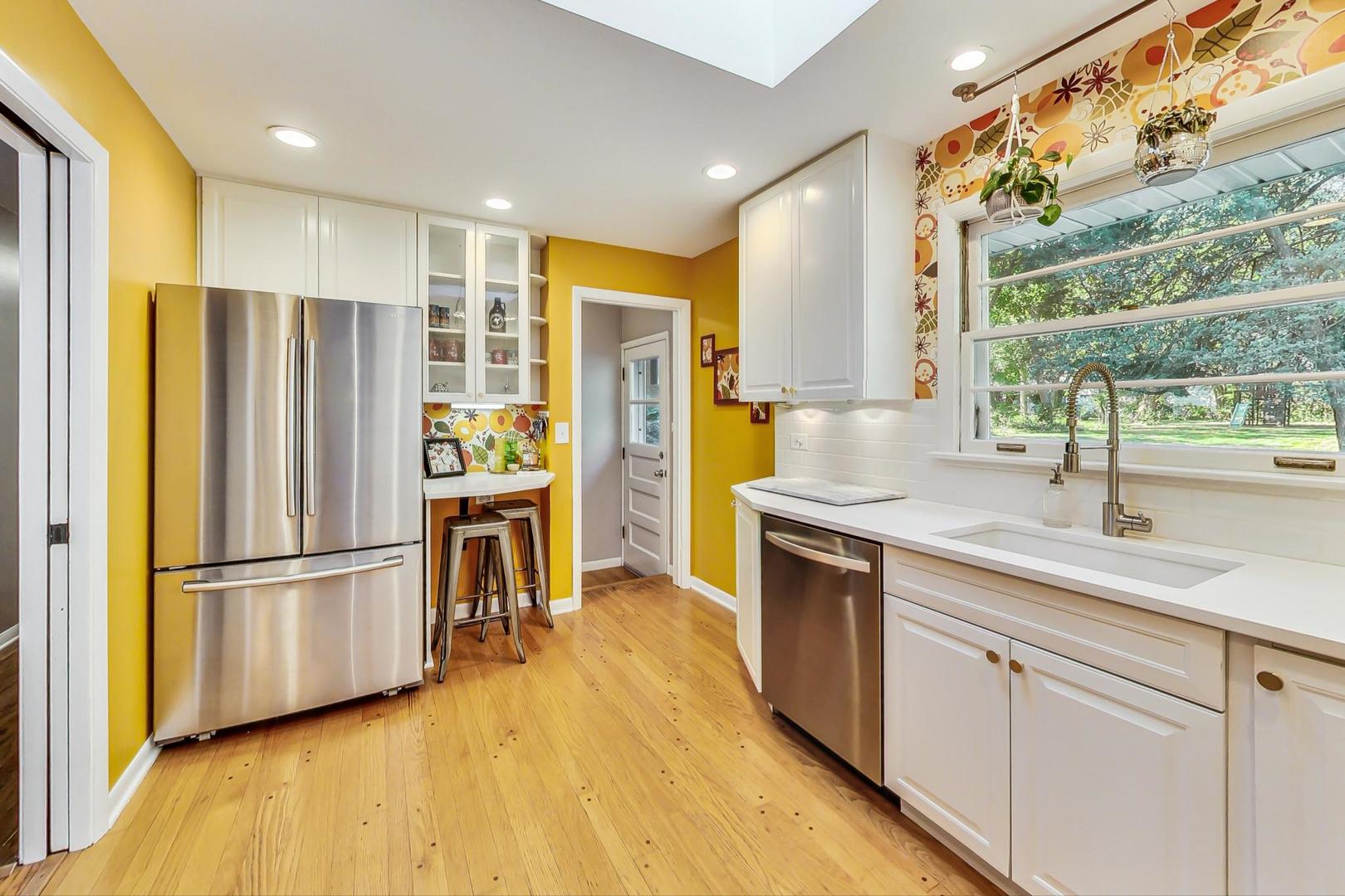 820 Sunset Road Wheaton, IL 60189 - Photo 6 of 32 a kitchen with stainless steel appliances granite countertop a refrigerator and a sink