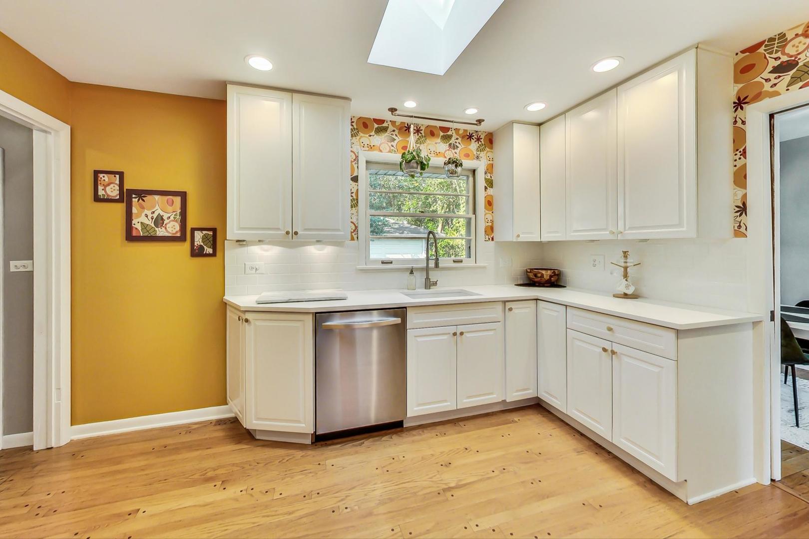 820 Sunset Road Wheaton, IL 60189 - Photo 7 of 32 a kitchen with sink cabinets and wooden floor