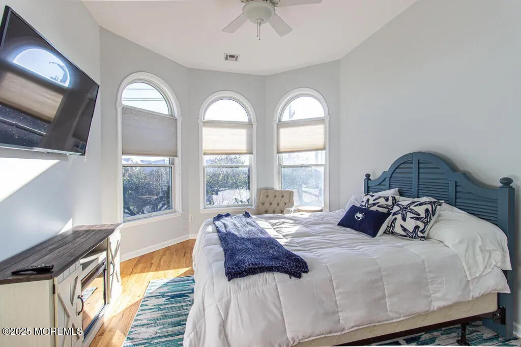 303 Highway 35, Unit 1 Point Pleasant Beach, NJ 08742 - Photo 11 of 25 a bedroom with a bed and a large window