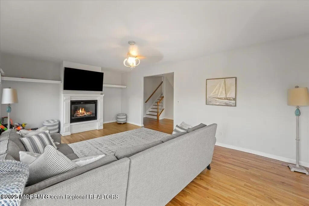 303 Highway 35, Unit 1 Point Pleasant Beach, NJ 08742 - Photo 13 of 25 a living room with furniture and a flat screen tv