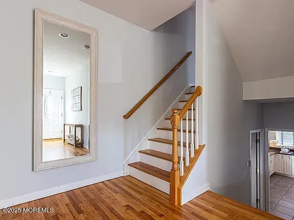 a view of entryway and hall with wooden floor