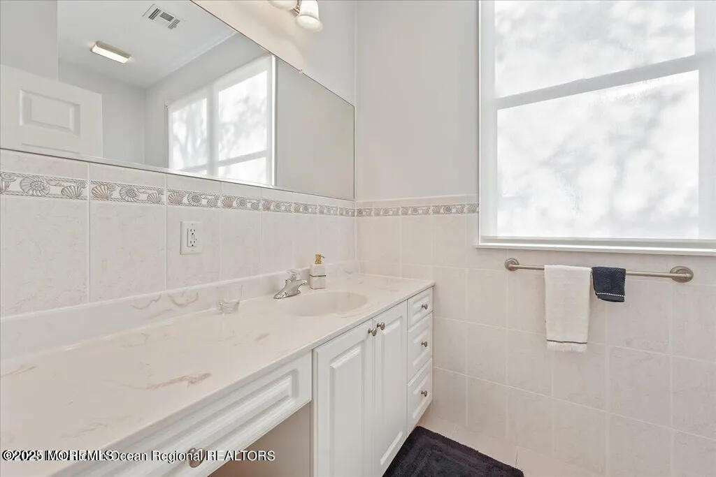 303 Highway 35, Unit 1 Point Pleasant Beach, NJ 08742 - Photo 20 of 25 a bathroom with a sink and a mirror