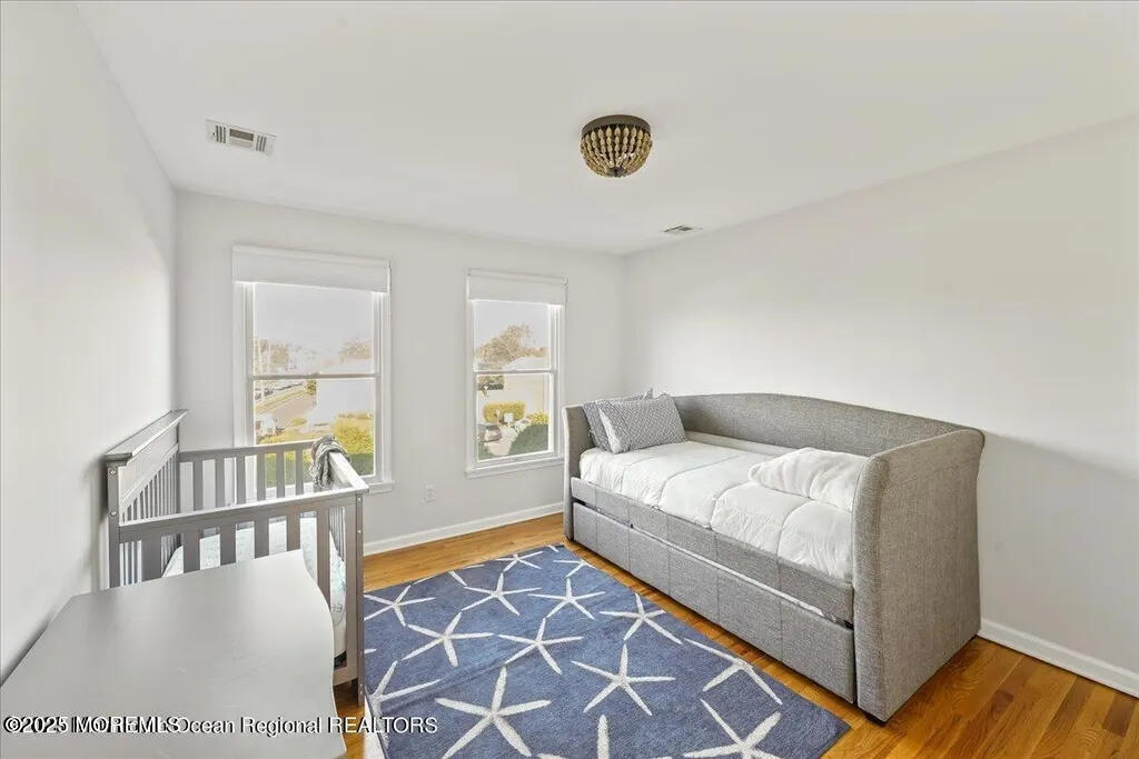 303 Highway 35, Unit 1 Point Pleasant Beach, NJ 08742 - Photo 23 of 25 a bedroom with a bed and a table