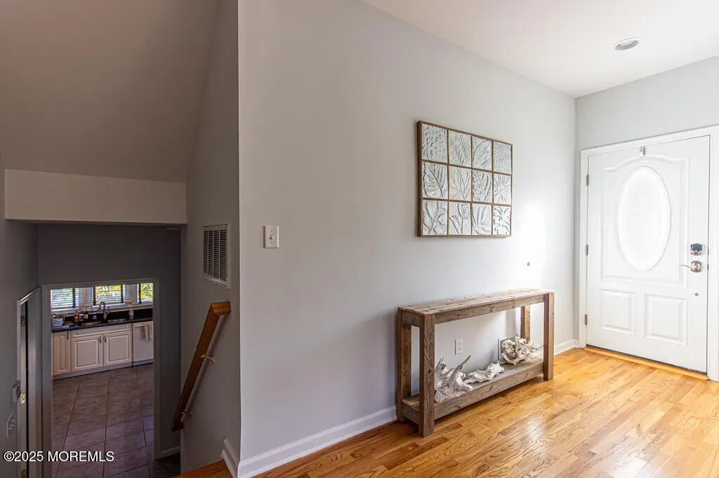 303 Highway 35, Unit 1 Point Pleasant Beach, NJ 08742 - Photo 24 of 25 a view of an empty room with window and wooden floor