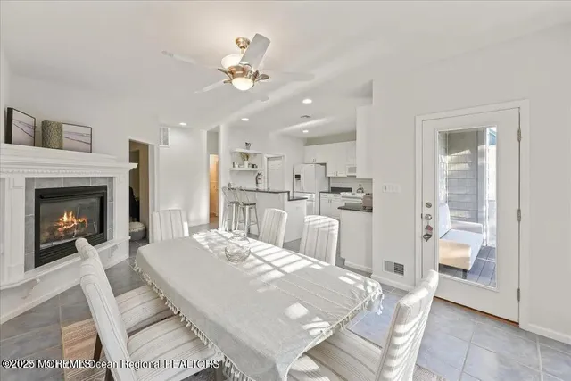 a living room with kitchen island furniture and a fireplace