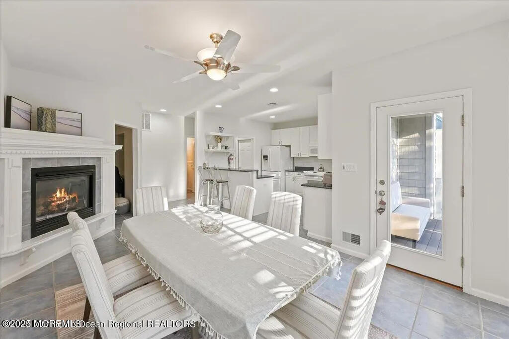 303 Highway 35, Unit 1 Point Pleasant Beach, NJ 08742 - Photo 7 of 25 a living room with kitchen island furniture and a fireplace