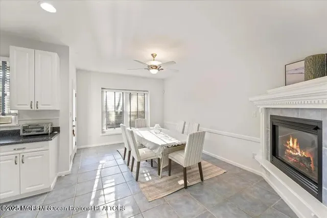 a view of a dining room with furniture and a fireplace