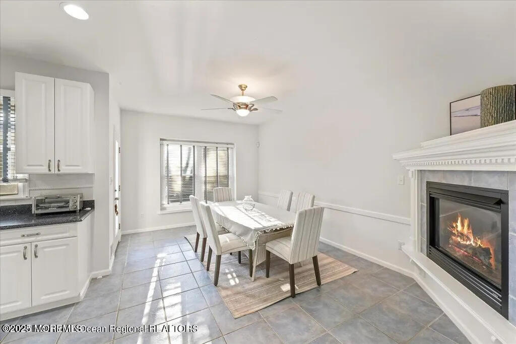 303 Highway 35, Unit 1 Point Pleasant Beach, NJ 08742 - Photo 10 of 25 a view of a dining room with furniture and a fireplace