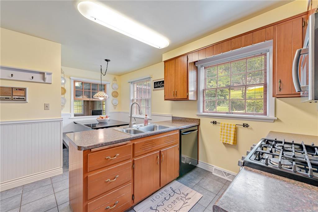 905 Lombard Street Irwin, PA 15642 - Photo 12 of 30 a kitchen with stainless steel appliances granite countertop a sink stove and refrigerator