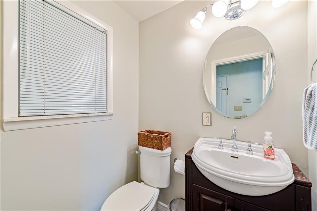 905 Lombard Street Irwin, PA 15642 - Photo 15 of 30 a bathroom with a sink a toilet and a mirror