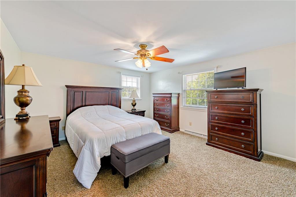 905 Lombard Street Irwin, PA 15642 - Photo 18 of 30 a bedroom with a bed and a chandelier