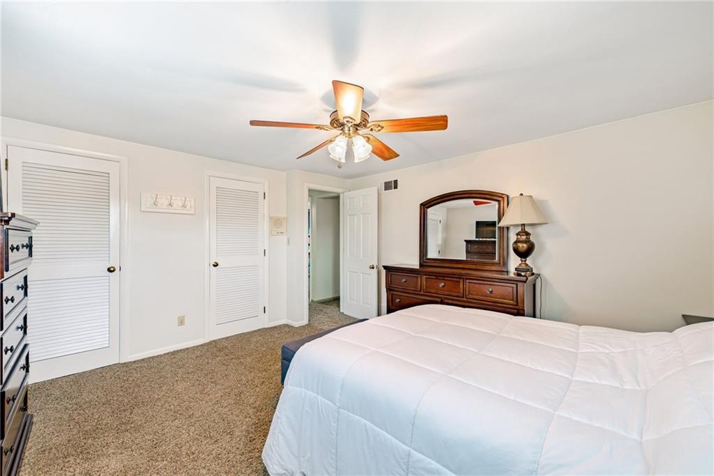 905 Lombard Street Irwin, PA 15642 - Photo 19 of 30 a bedroom with a bed and a chandelier