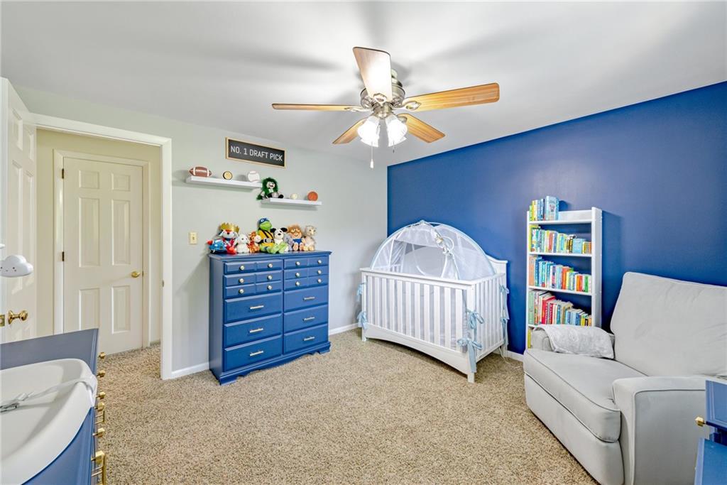 905 Lombard Street Irwin, PA 15642 - Photo 22 of 30 a bedroom with a bed and a chandelier