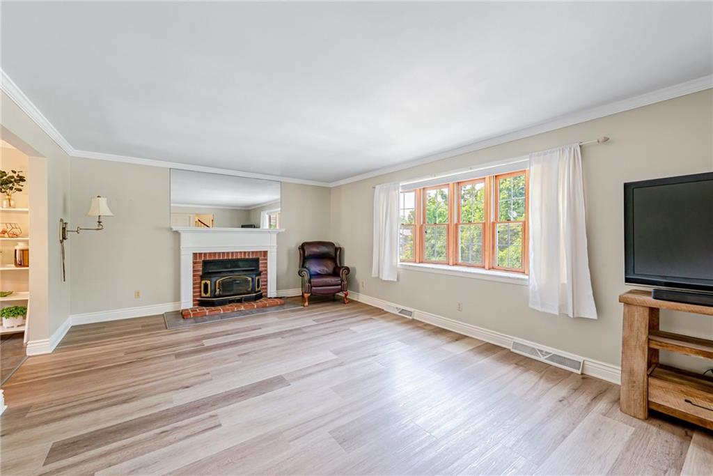 905 Lombard Street Irwin, PA 15642 - Photo 4 of 30 a view of a livingroom with a fireplace and a window
