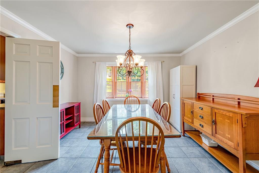 905 Lombard Street Irwin, PA 15642 - Photo 6 of 30 a dining room with furniture a chandelier