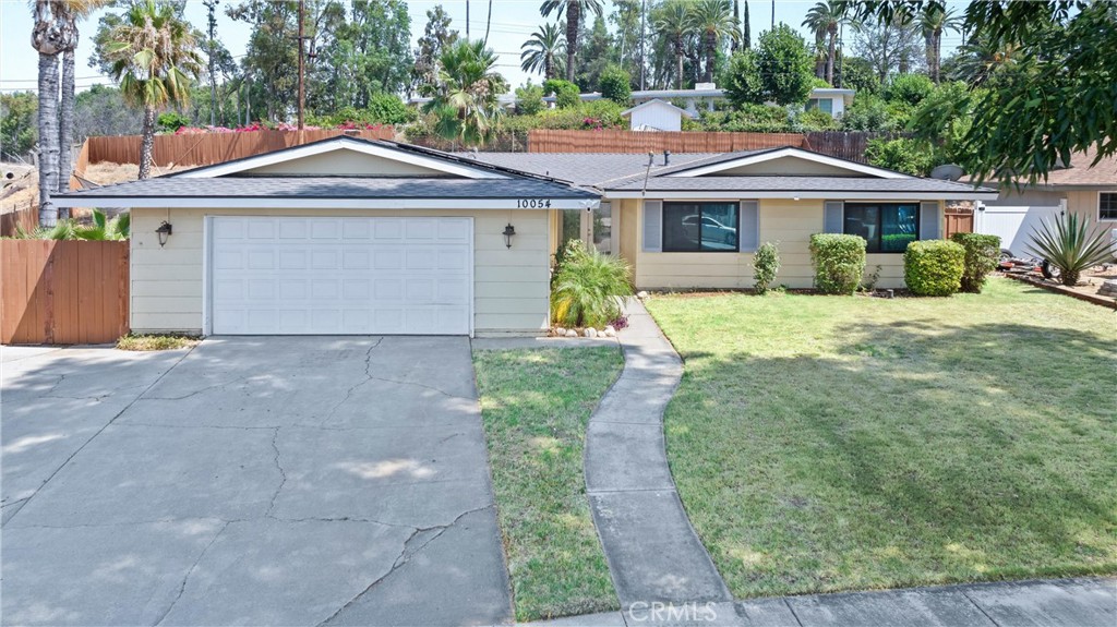 10054 Shady View Street Riverside, CA 92503 - Photo 1 of 1 a front view of a house with a yard and garage