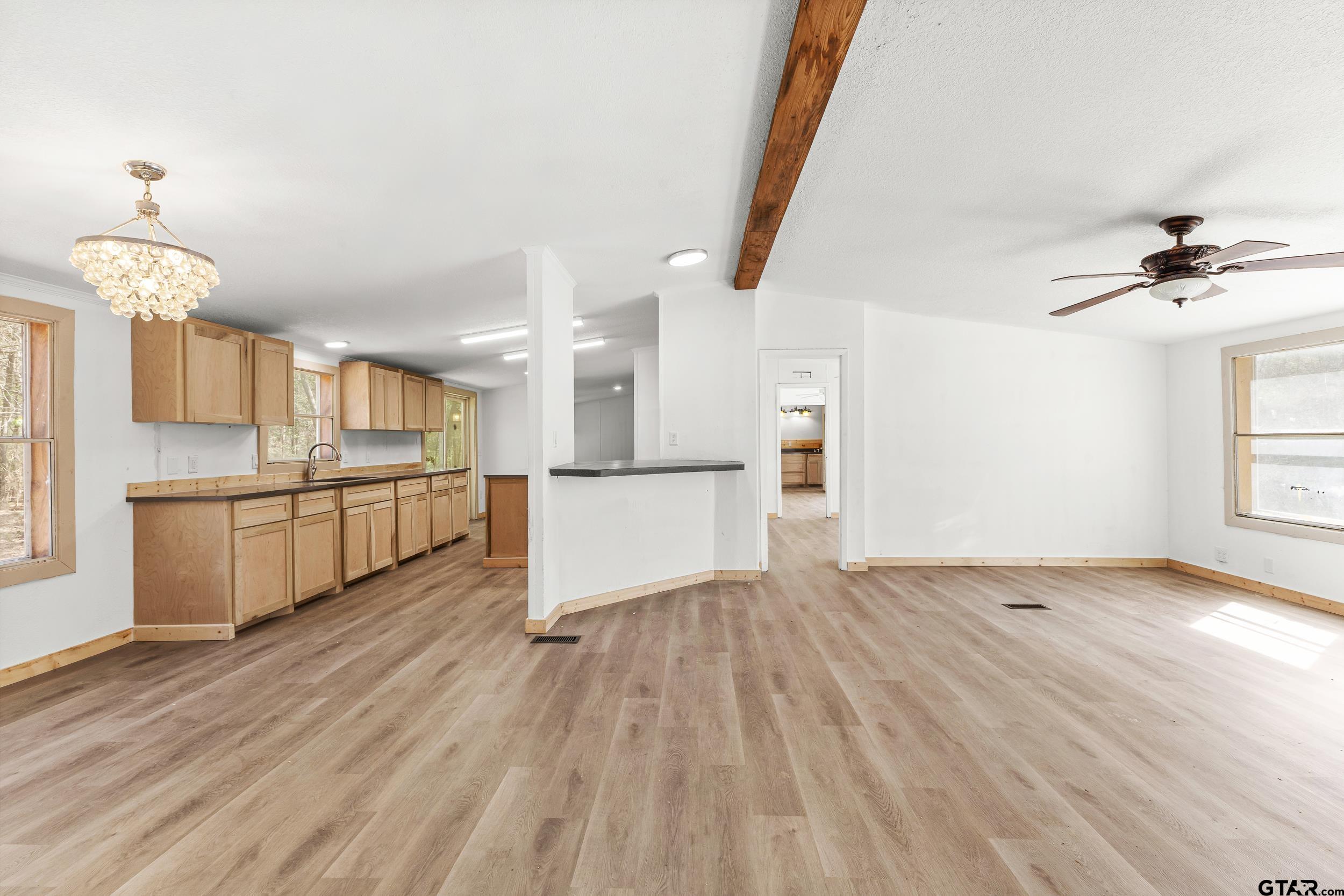 180 Southeast County Road Southeast Mount Vernon, TX 75457 - Photo 7 of 32 a view of a kitchen with wooden floor and a kitchen