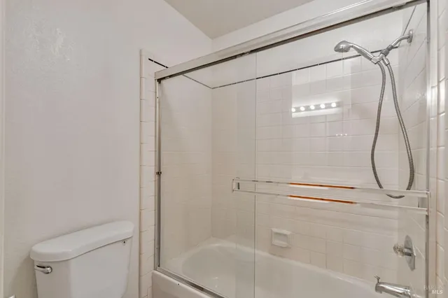 a bathroom with a glass shower door