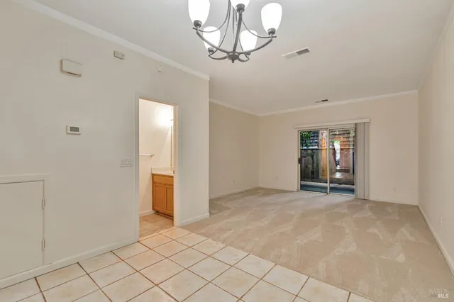 a view of empty room with chandelier