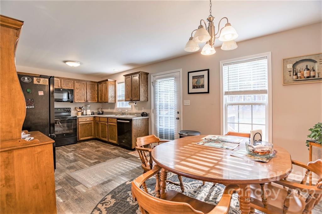 1577 State Rd S-46-323 York, SC 29745 - Photo 9 of 34 a kitchen with a table chairs appliances and cabinets