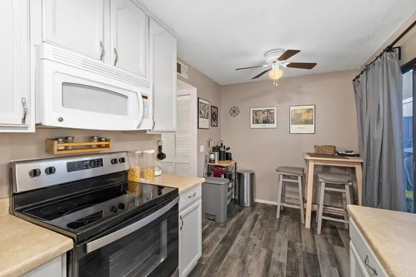 a kitchen with stainless steel appliances a stove a sink and cabinets