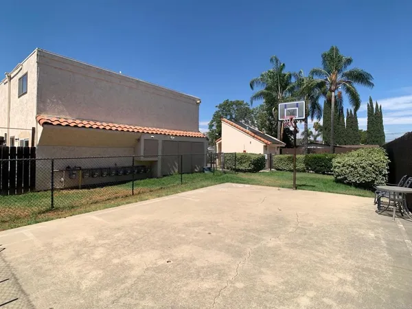 a view of house with backyard and tree