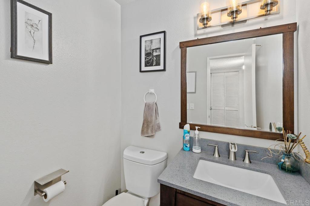 12553 Mapleview Street, Unit 28 Lakeside, CA 92040 - Photo 8 of 26 a bathroom with a toilet a sink and mirror