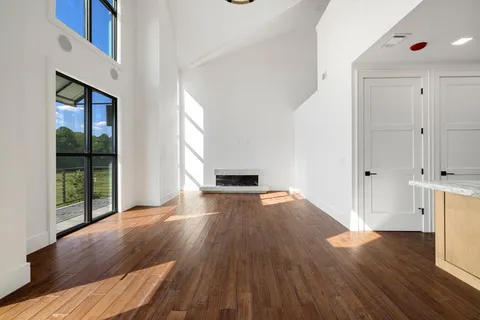a view of kitchen with granite countertop cabinets and wooden floor