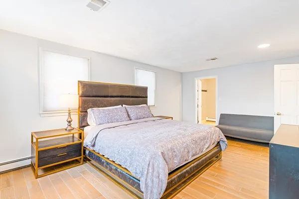 a bedroom with a bed and a couch