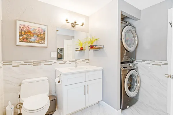 a bathroom with a toilet a sink and a mirror
