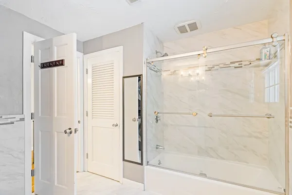 a bathroom with a glass shower door