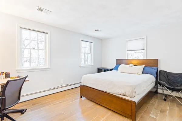 a bedroom with a bed and window