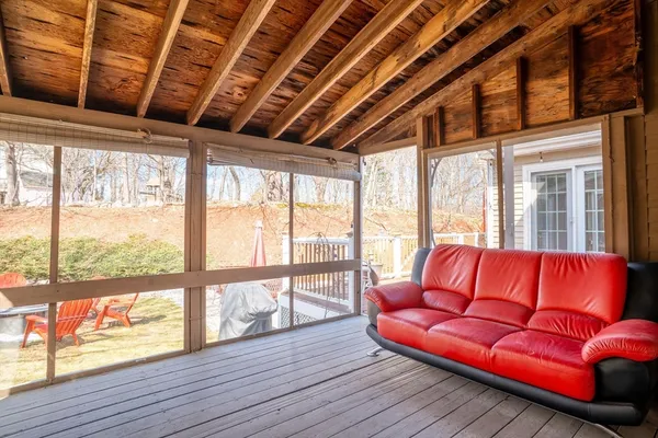a living room with furniture with wooden floor and windows