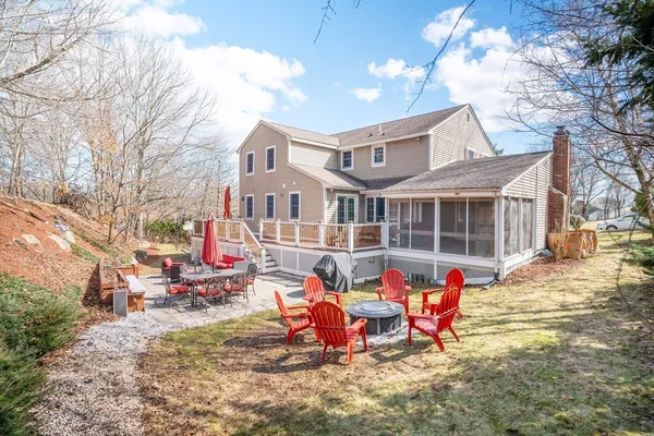 a view of a house with backyard and sitting area