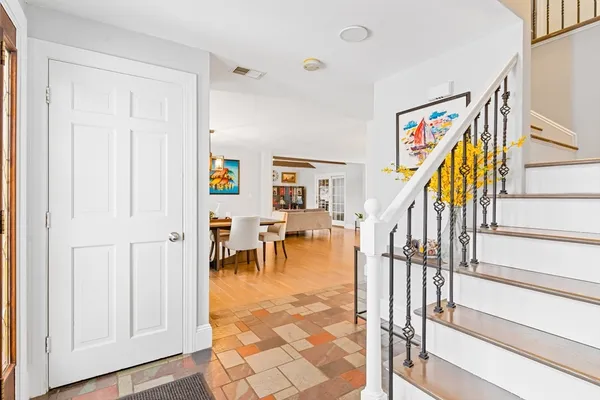 a view of dining room with wooden floor and stairs