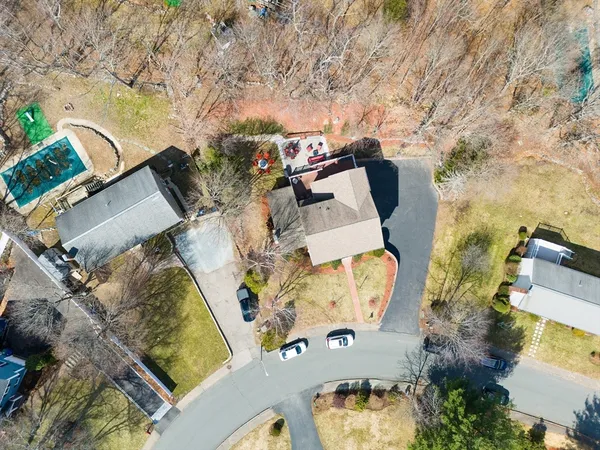 an aerial view of a house with a swimming pool