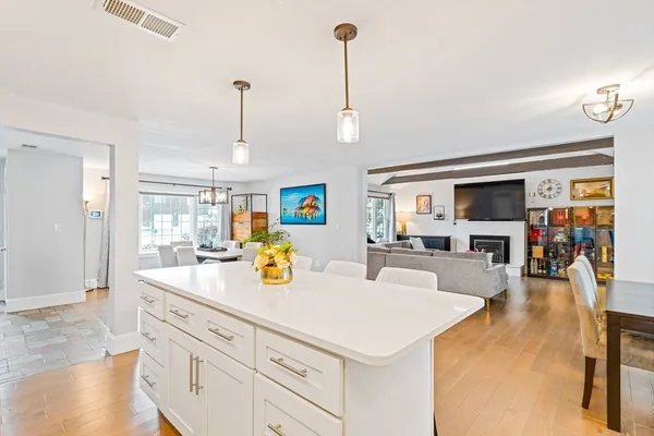 a view of living room with kitchen island furniture and wooden floor