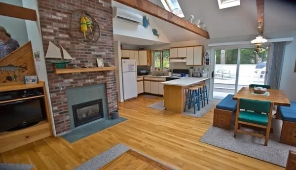 a living room with furniture a fireplace and a table
