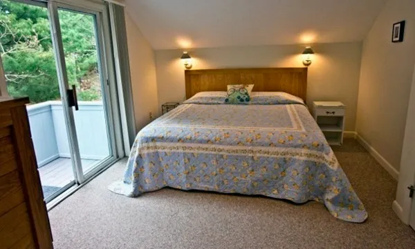 a bed sitting in a room next to a window