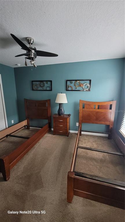 1040 Marcello Boulevard Kissimmee, FL 34746 - Photo 12 of 24 a bedroom with a bed and dresser