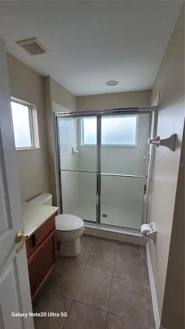 a bathroom with a shower and a toilet